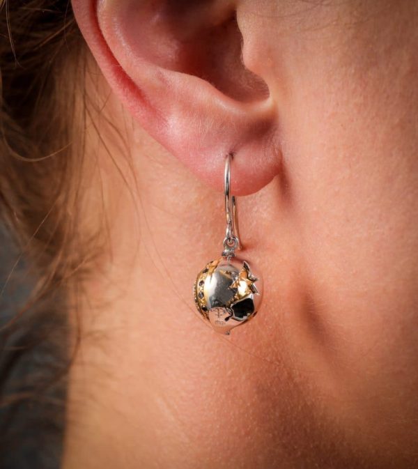 18 carat white and yellow gold 'Eclipse' hook earrings, set with black and white diamonds, with a rotating outer white gold shell