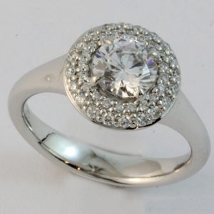Claw set halo diamond cluster ring, set with a 1ct diamond centre.